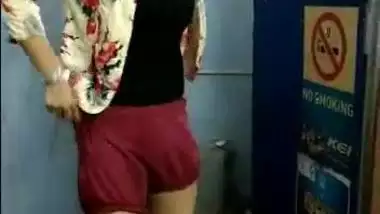 Indian teen shows skinny legs wearing panties while putting shorts on